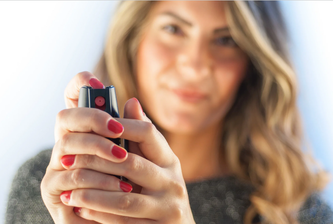 image of a woman holding a pepper spray canister